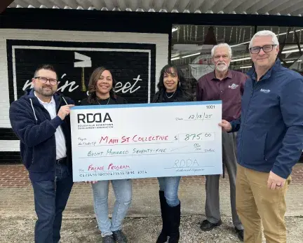 Four people standing in front of a store