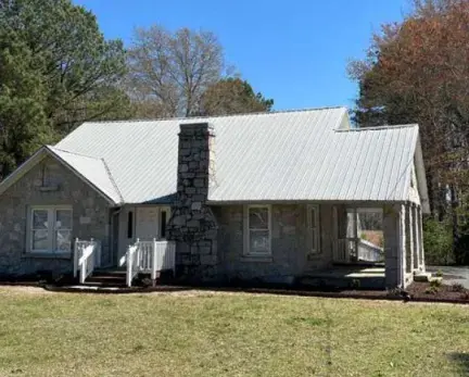 Gray stone building with chimney. It is the planning department offices.