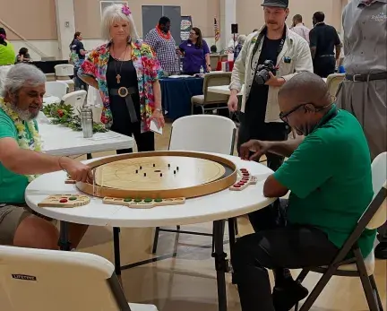 June Greene playing Crokinole at the Golden Years Expo