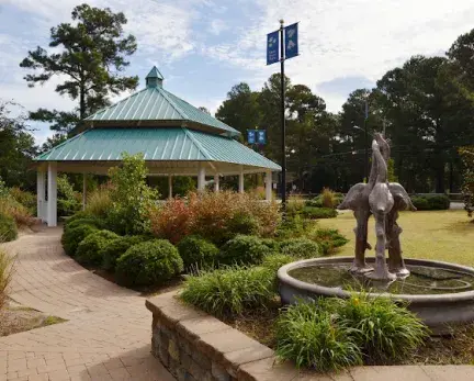 Main Street Park Gazebo that is teal green and a fountain in front of it.