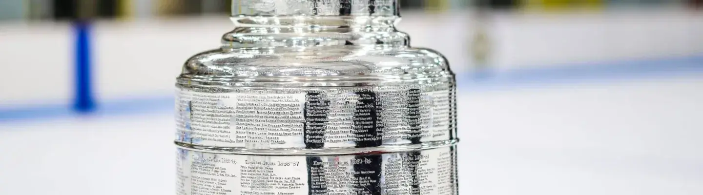 Image of the Stanley Cup on a table, set up on an ice rink.
