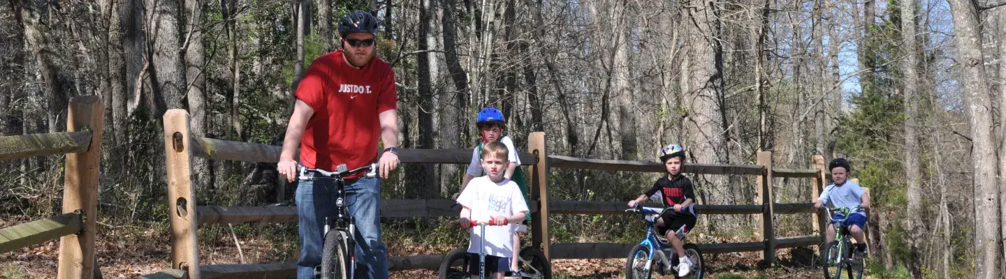 Family riding bikes on greenway