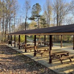 brown shelter with picnic tables at Main Street Park. 