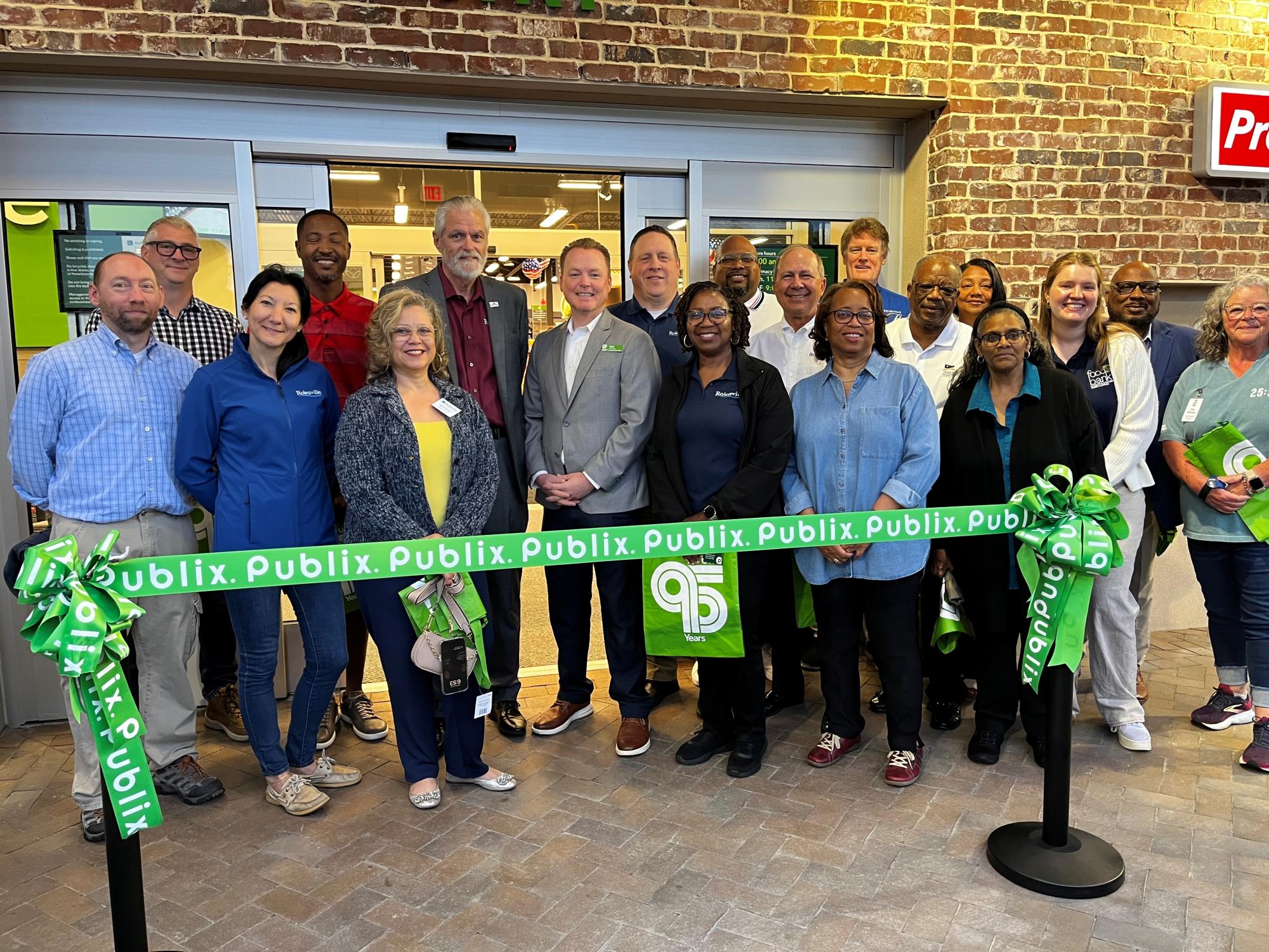 Town of Rolesville commissioners, mayor and staff with the Publix store manager at the ribbon cutting.